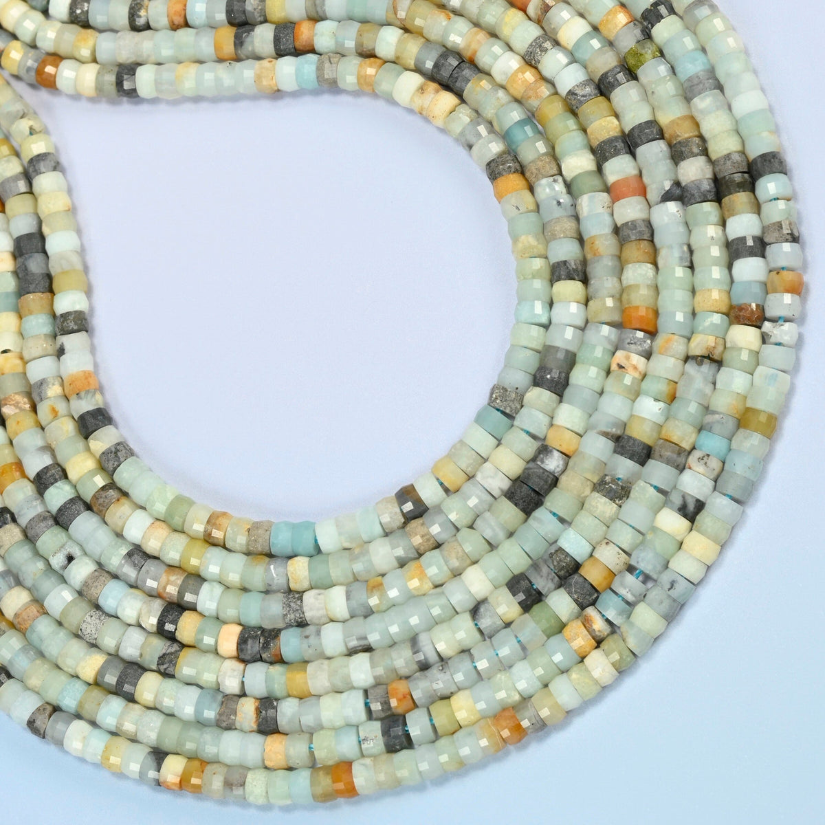 Multi-color amazonite faceted heishi disc beads curved into an open loop, blue-green, cream, yellow and gray beads