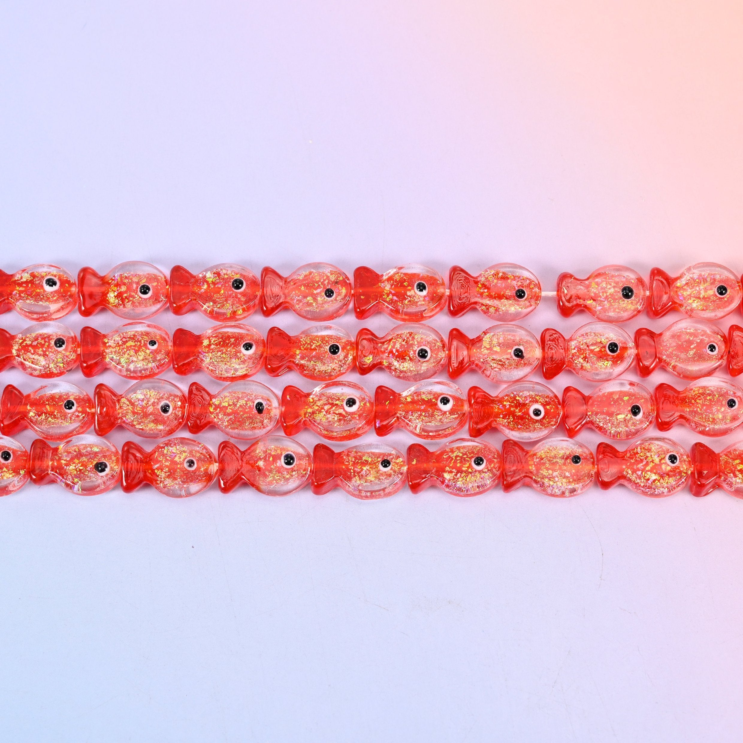 Red Fish Glass Beads with coral red heads and tails, gold glitter flecks