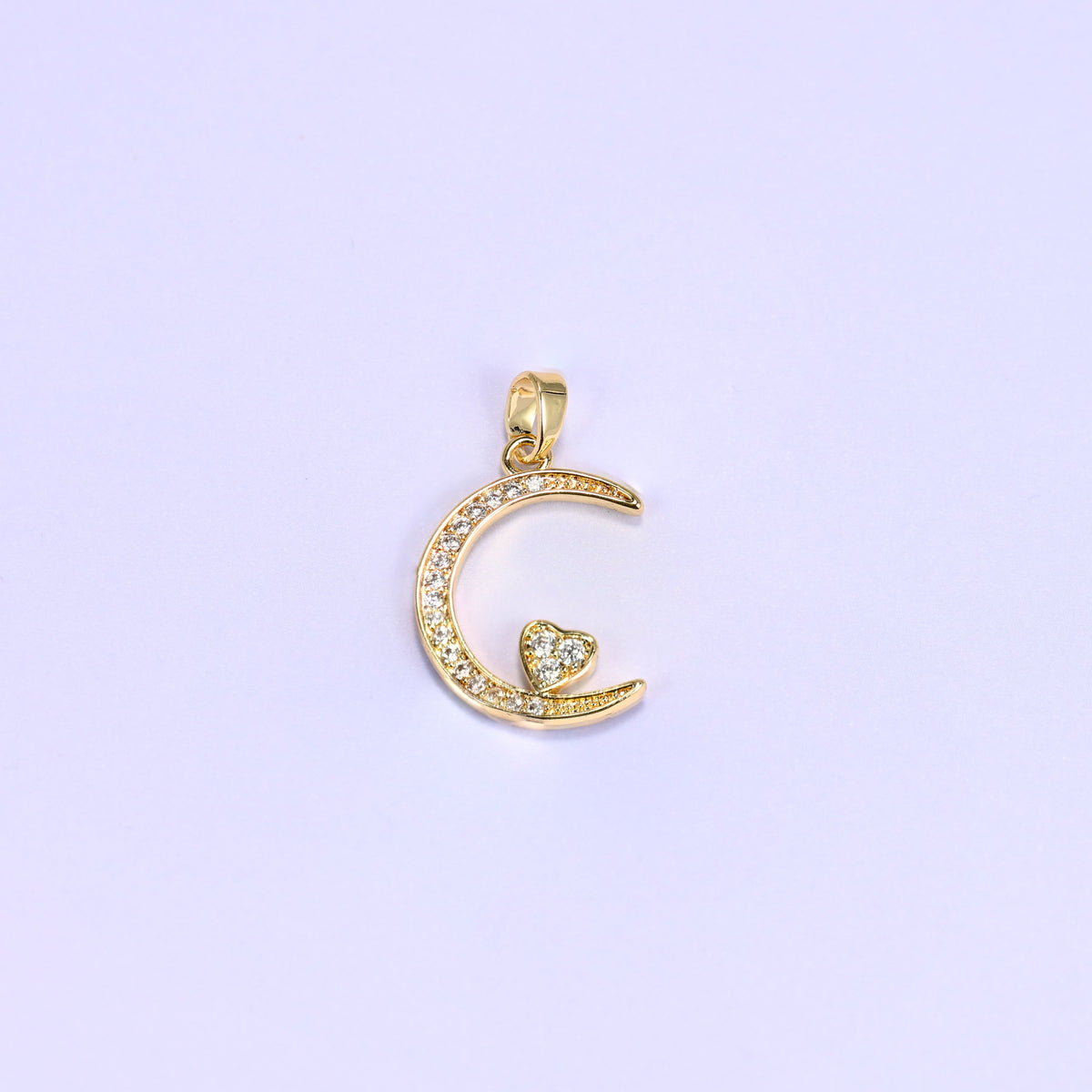 18K gold plated moon heart zirconia charm shown on its own, the crescent lined with clear pave and a heart tucked inside the curve.