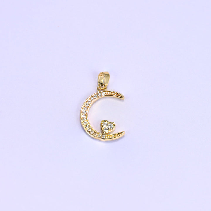 18K gold plated moon heart zirconia charm shown on its own, the crescent lined with clear pave and a heart tucked inside the curve.