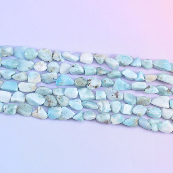 Strands stretched flat, the small tumbled nuggets showing how their sizes and shapes differ