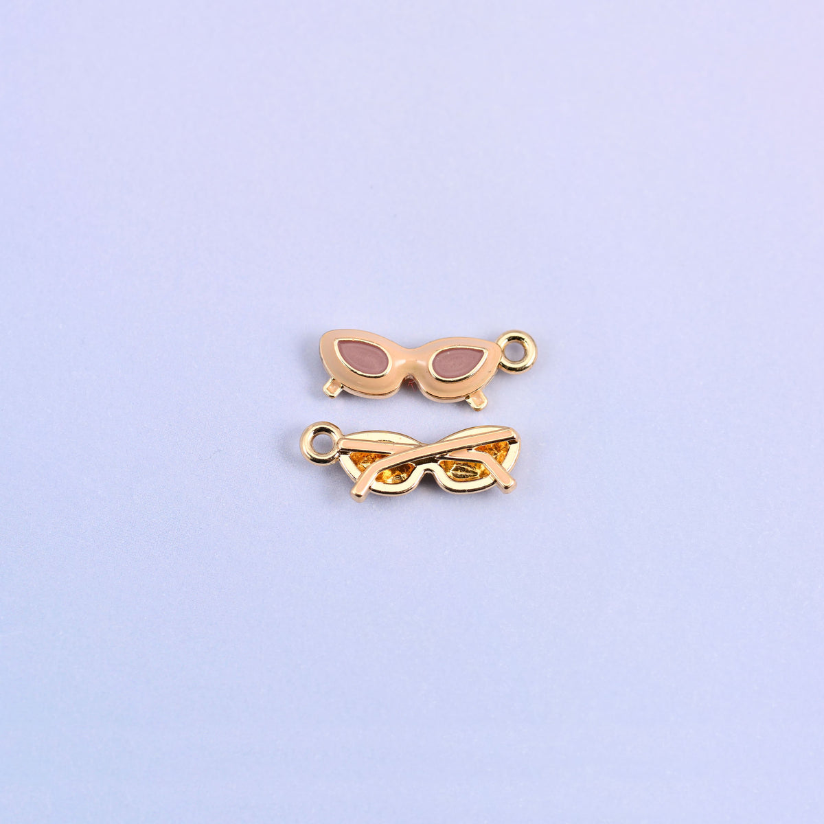 Brown cat eye sunglasses charm with light pink lenses, front and back.