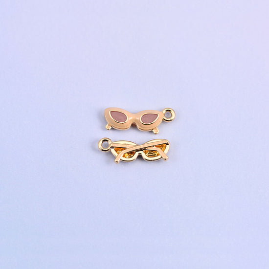 Brown cat eye sunglasses charm with light pink lenses, front and back.