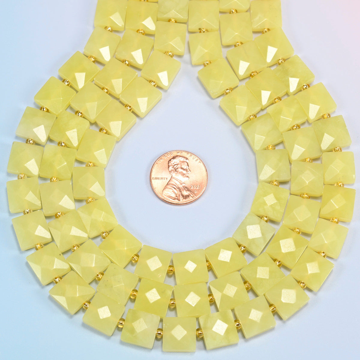 Lemon Jade faceted flat square strands formed into a teardrop loop around a US penny for scale