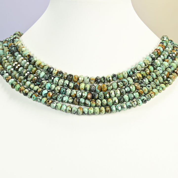 African Howlite gemstone rondelle beads 4x6mm shown on a white neck display as a layered necklace