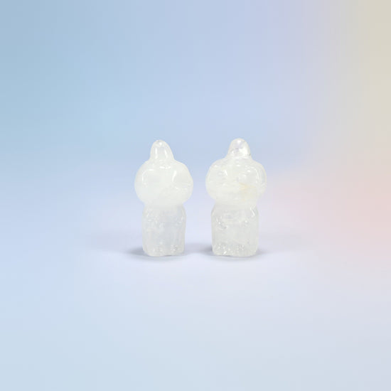 Two natural clear quartz pumpkin skull carvings, milky white with see-through edges