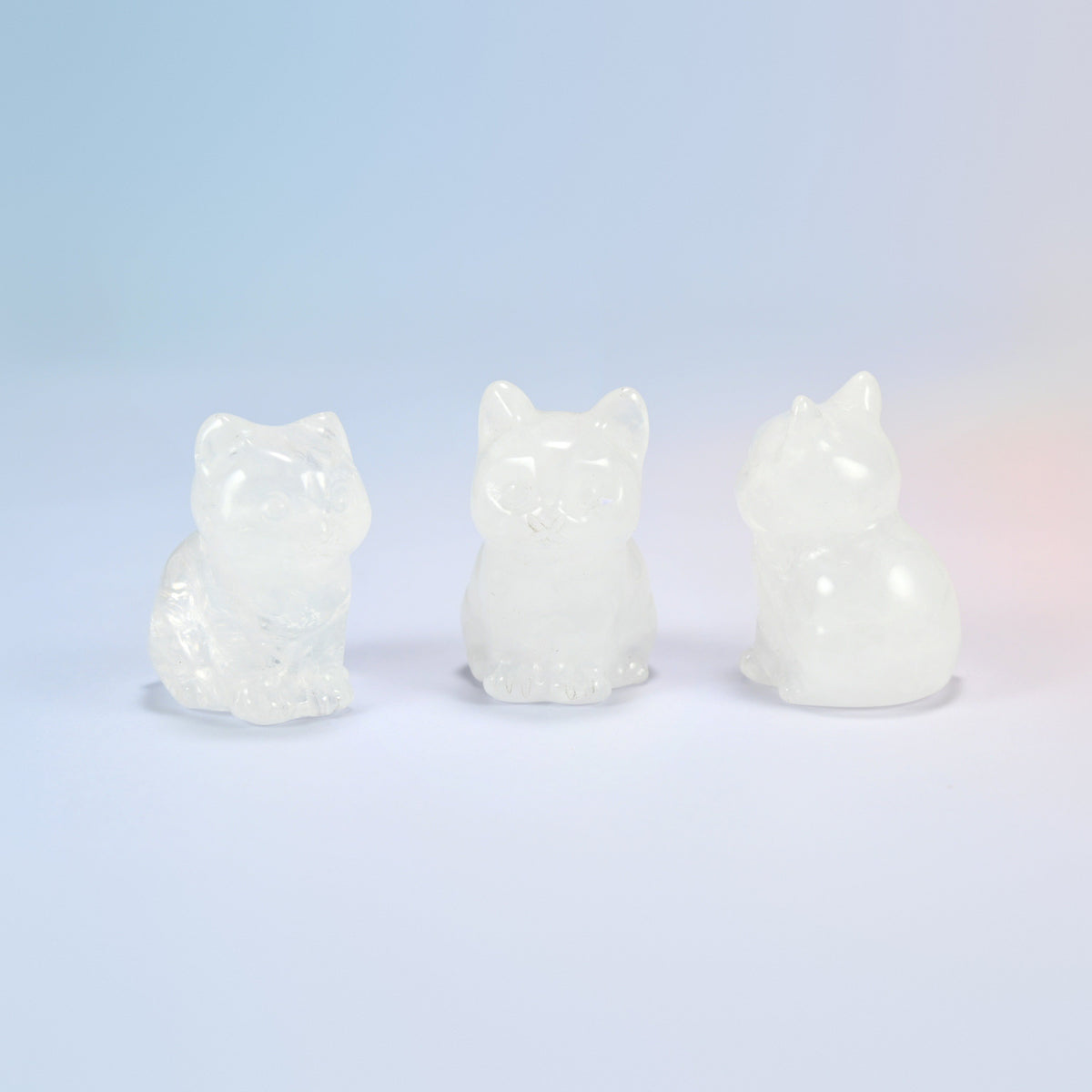 Three natural clear quartz sitting cat crystal carvings, 1.5 inch, icy clear