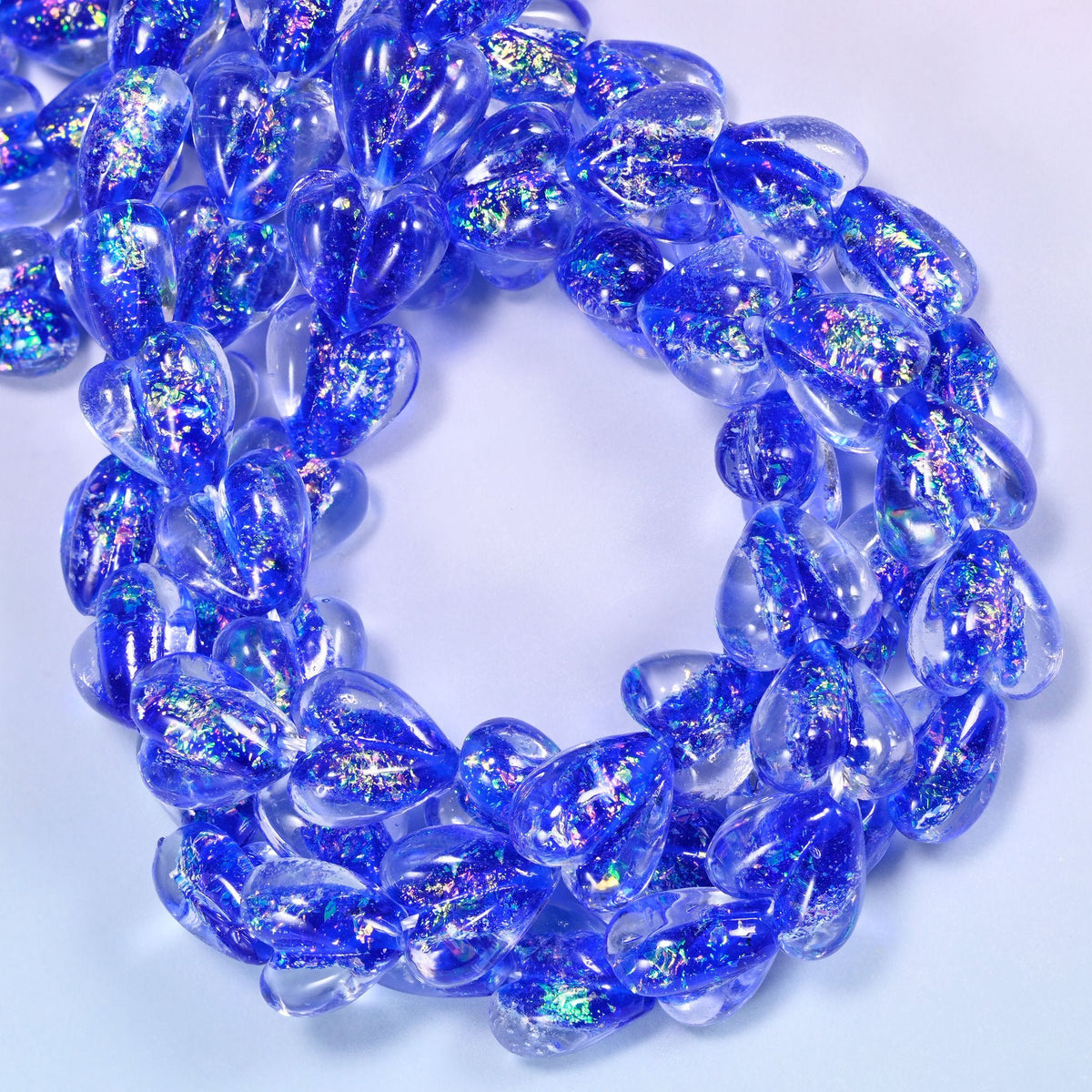 Transparent hearts in strong cobalt blue, thick and rounded, each holding a drift of iridescent glitter