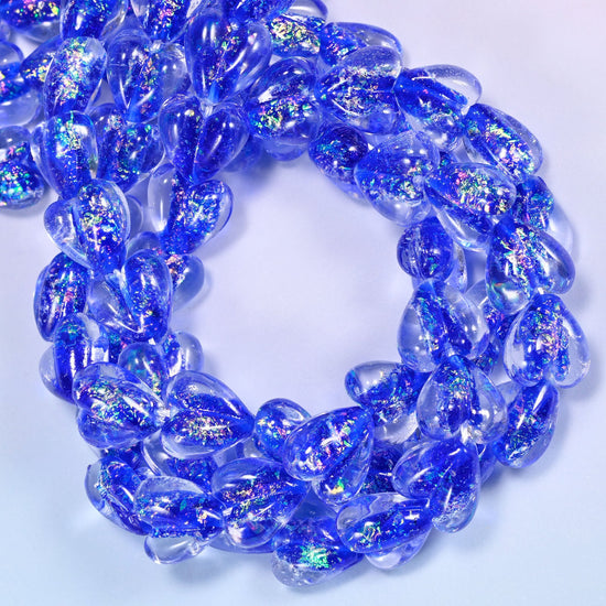 Transparent hearts in strong cobalt blue, thick and rounded, each holding a drift of iridescent glitter