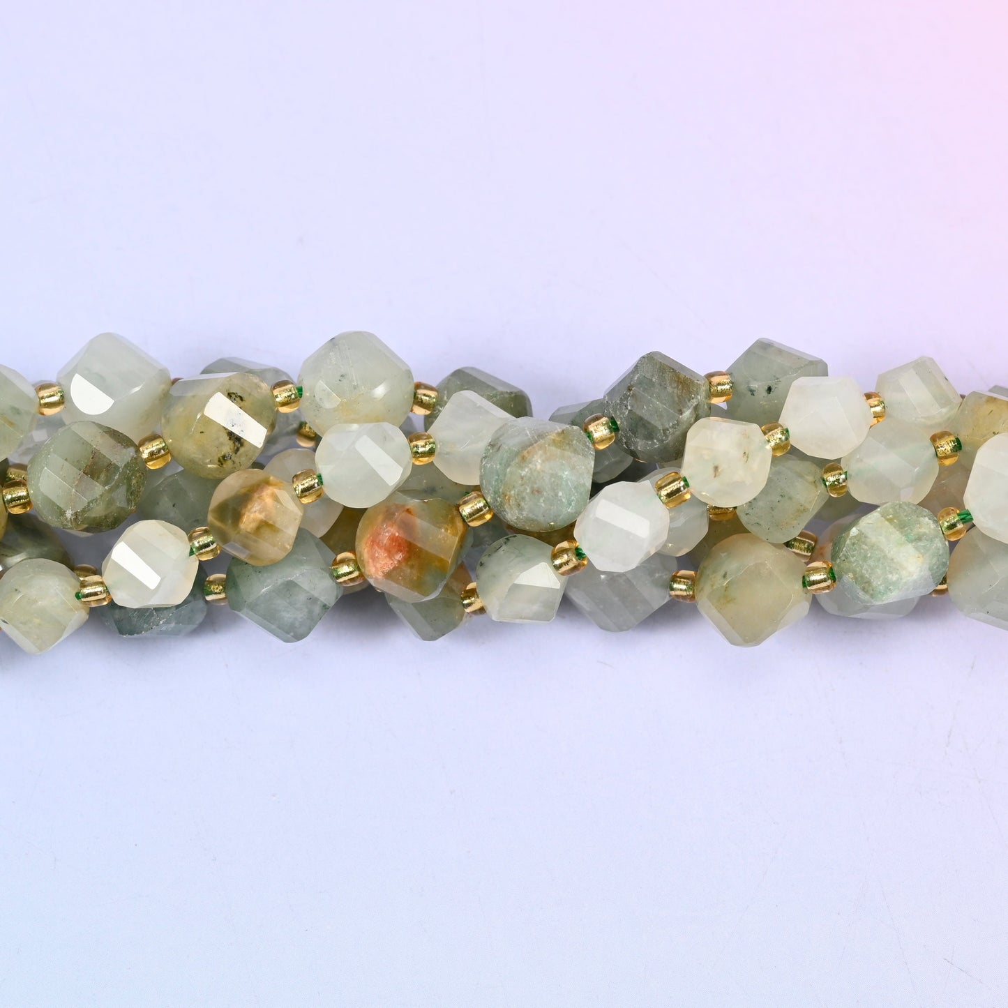 Green Grass Silk Stone Faceted Spiral Twist Beads, muted sage green threaded with cream and straw, with fine fibrous streaks