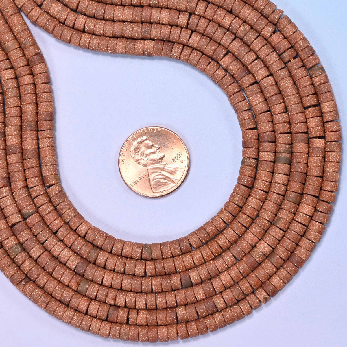 Matte gold sandstone heishi disc beads, approximately 155 per strand