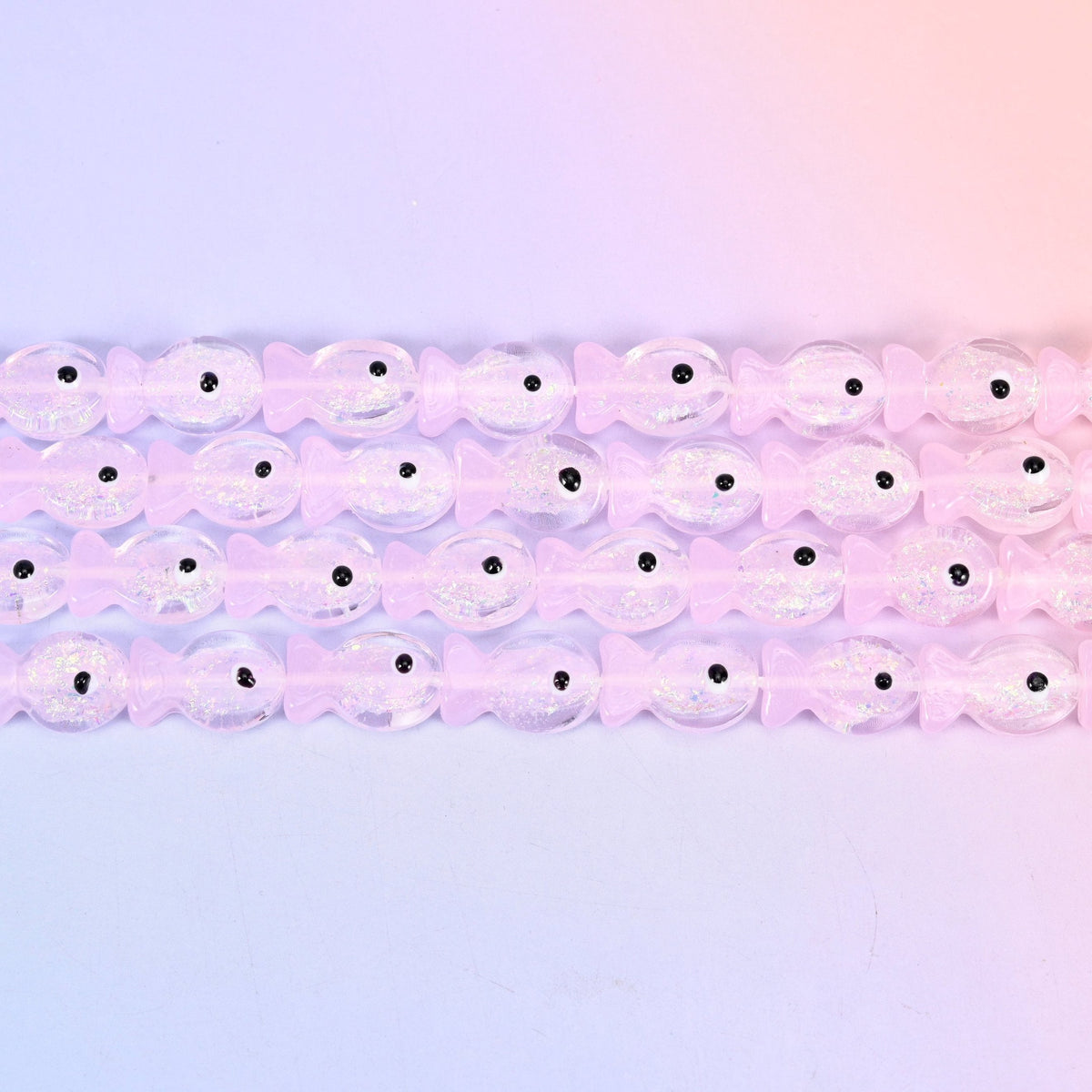 Iridescent Pink Fish Glass Beads in pale petal-pink with a pearly sheen