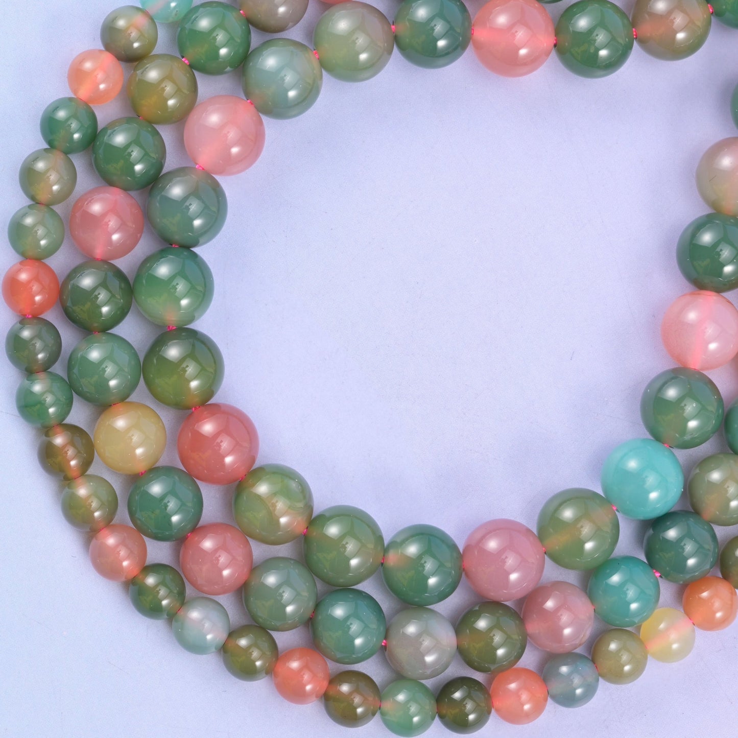 Green Yanyuan Agate round beads coiled into a loop, natural stone carrying green, pink and aqua in one strand