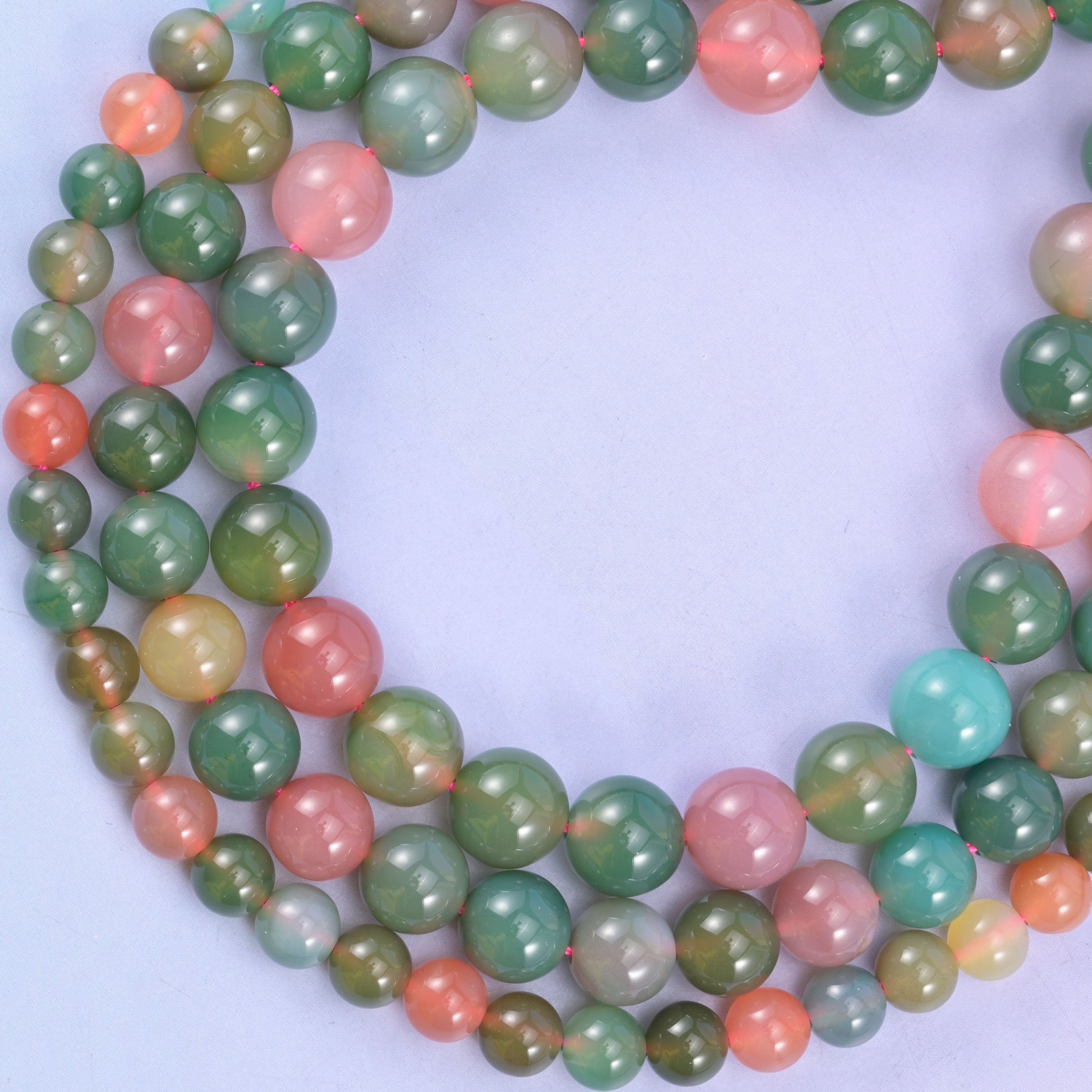 Green Yanyuan Agate round beads coiled into a loop, natural stone carrying green, pink and aqua in one strand