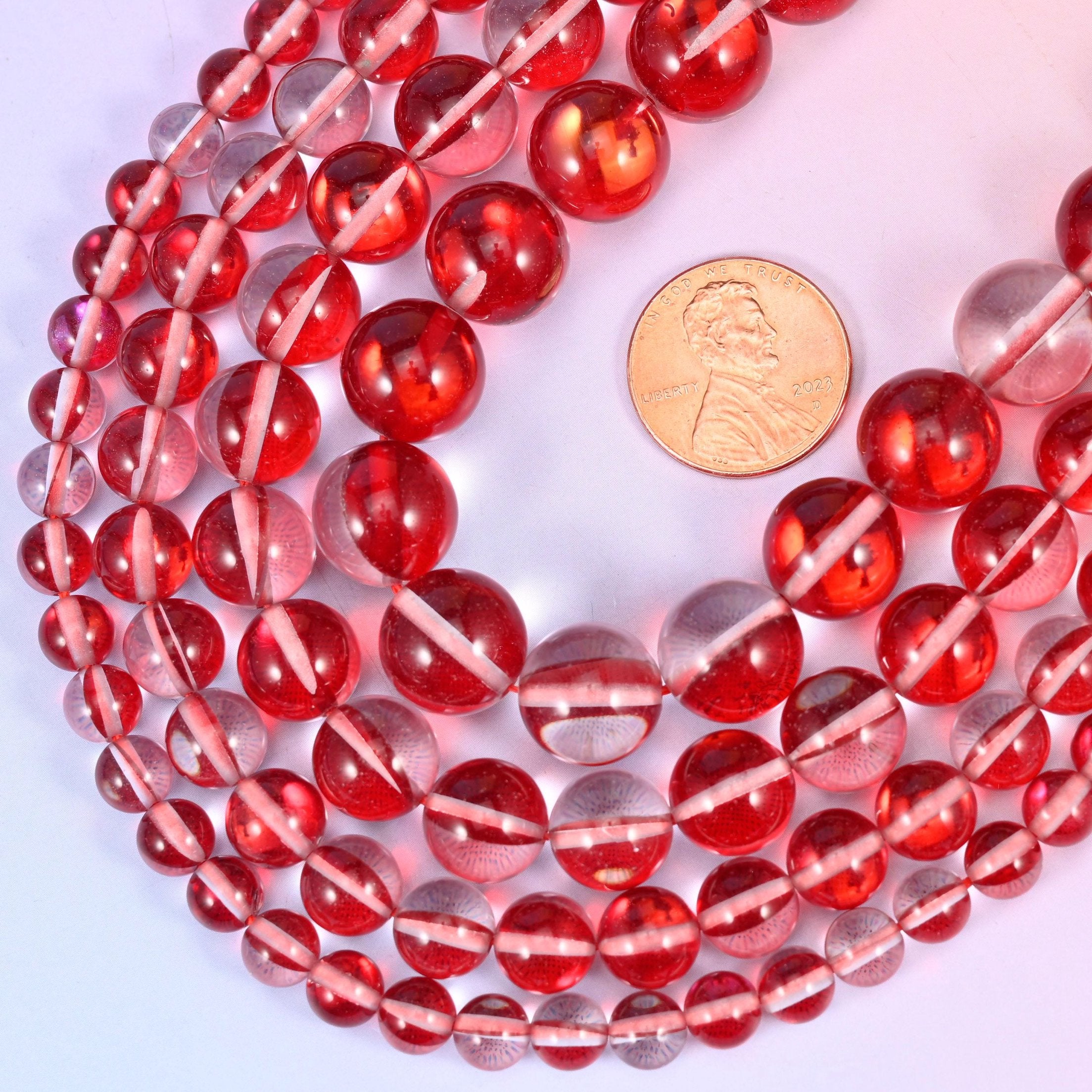 Round iridescent red glass beads with polished glassy shine