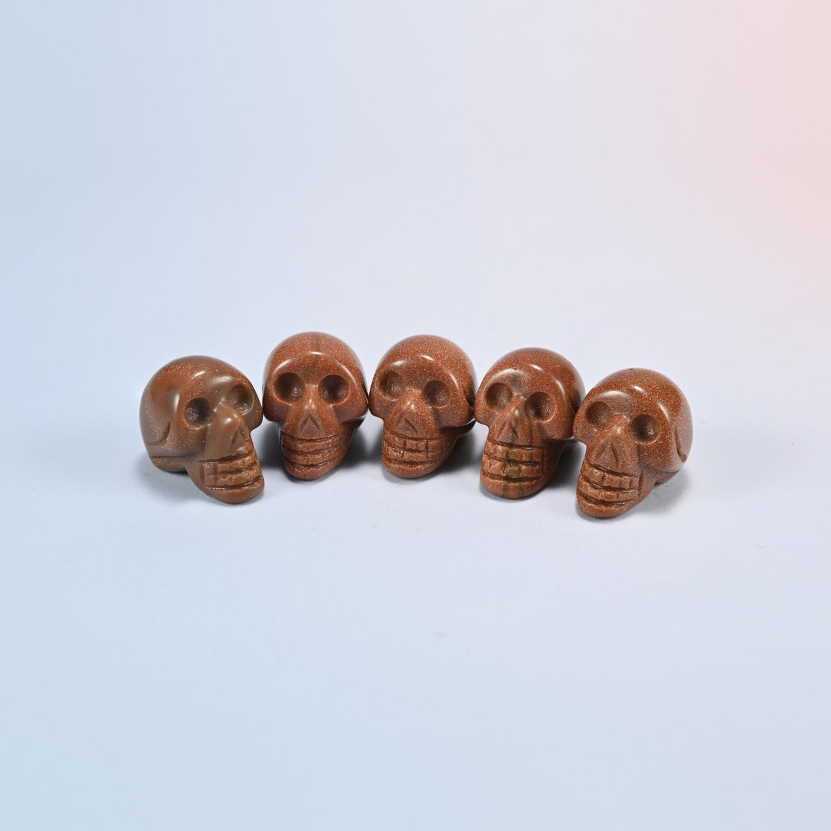 1 inch skull crystal carving in gold sandstone, golden brown man-made glass with sparkle
