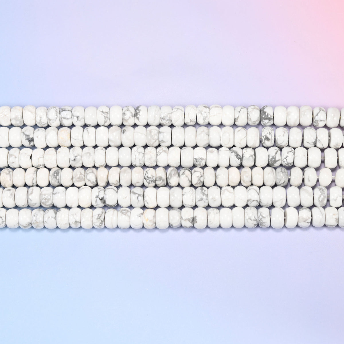 Natural White Howlite Rondelle Beads in soft white with gray marbled veining.