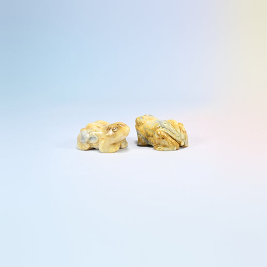 Two natural crazy agate frog carvings, yellow and gray swirled agate