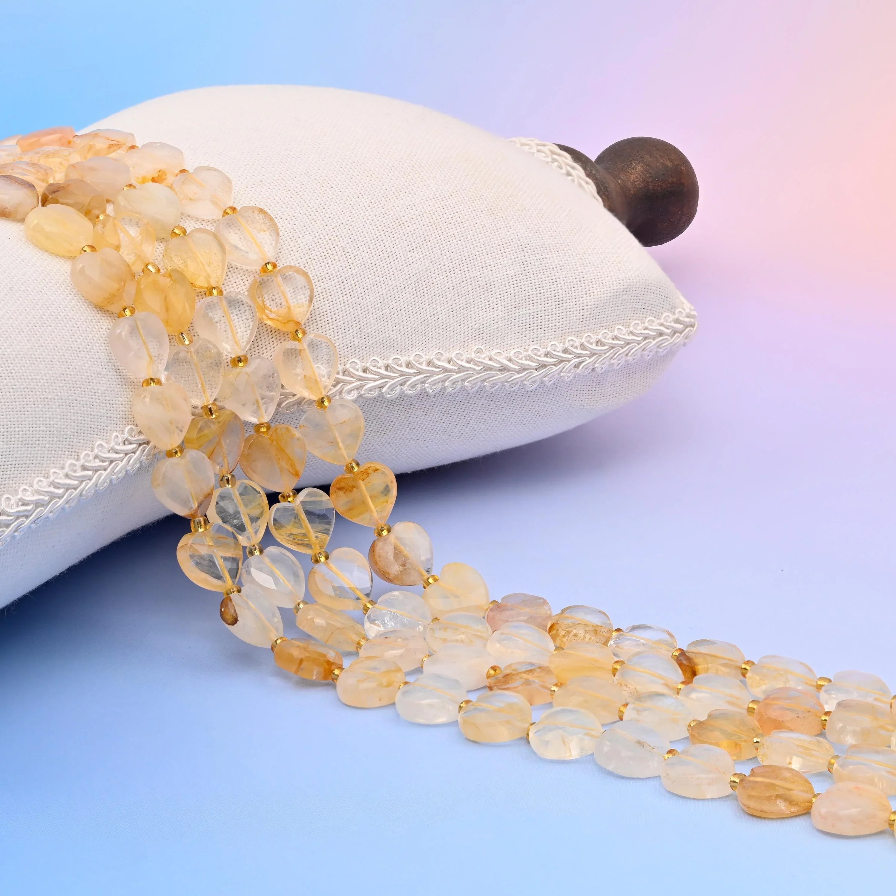Natural Golden Healer quartz faceted heart beads in warm golden tones