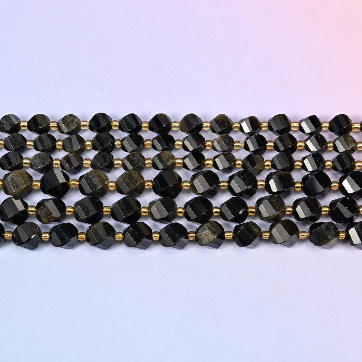 Gold Obsidian beads, mirror-black volcanic glass flaring to warm bronze-gold