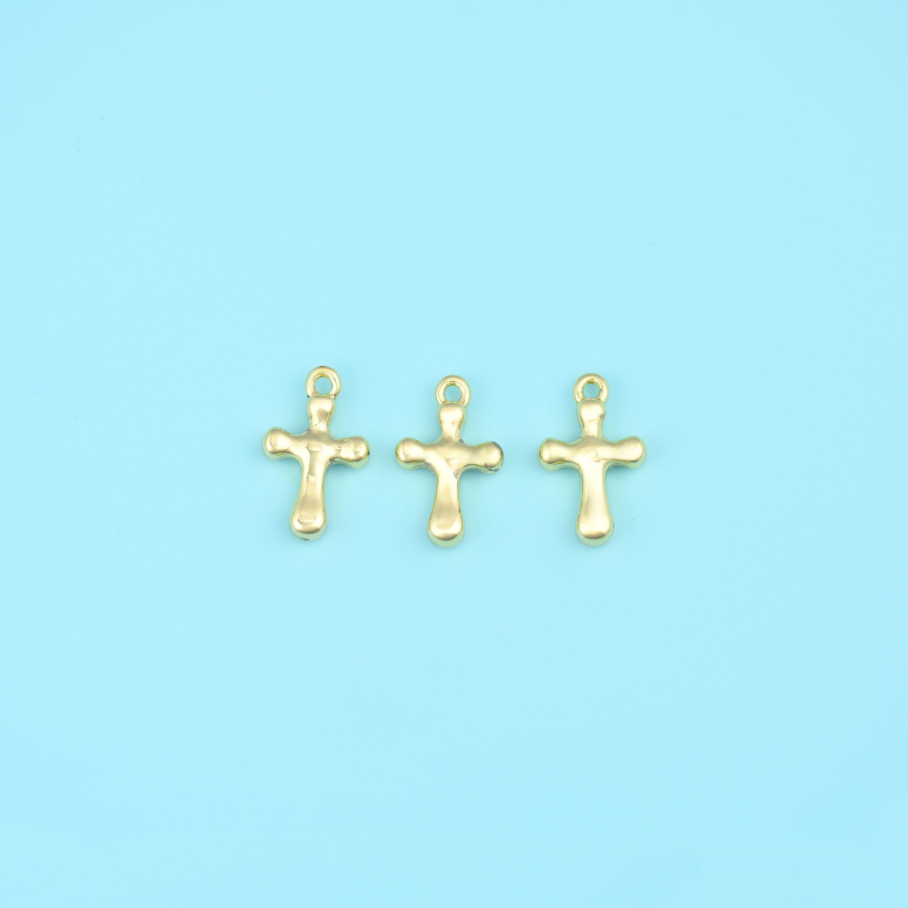 A small solid cross with softly rounded, slightly bulbed arm ends and a plain polished surface — no engraving, no stone…