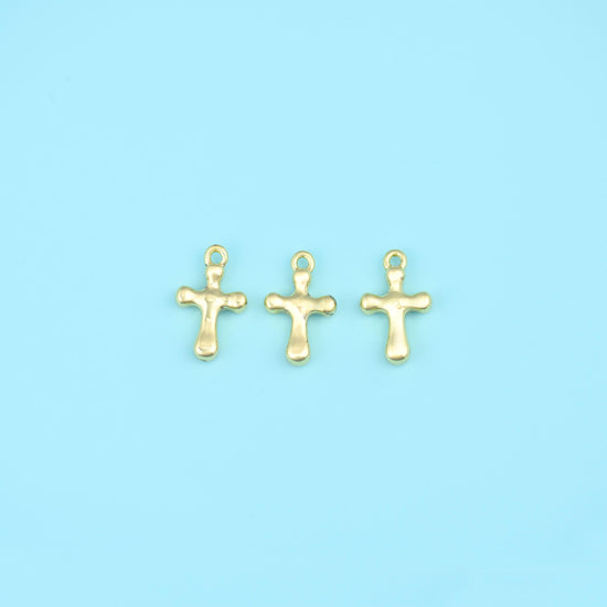 A small solid cross with softly rounded, slightly bulbed arm ends and a plain polished surface — no engraving, no stone…