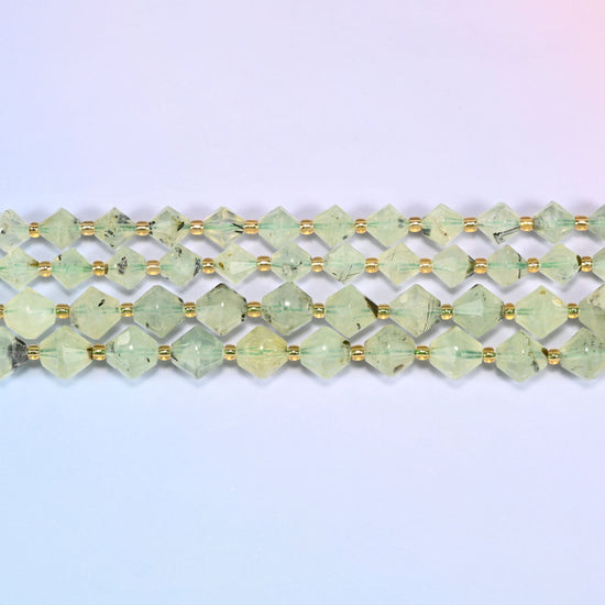 A single straight strand of Green Prehnite faceted bicone beads, 8mm and 10mm, laid flat showing the full 15 inch length.