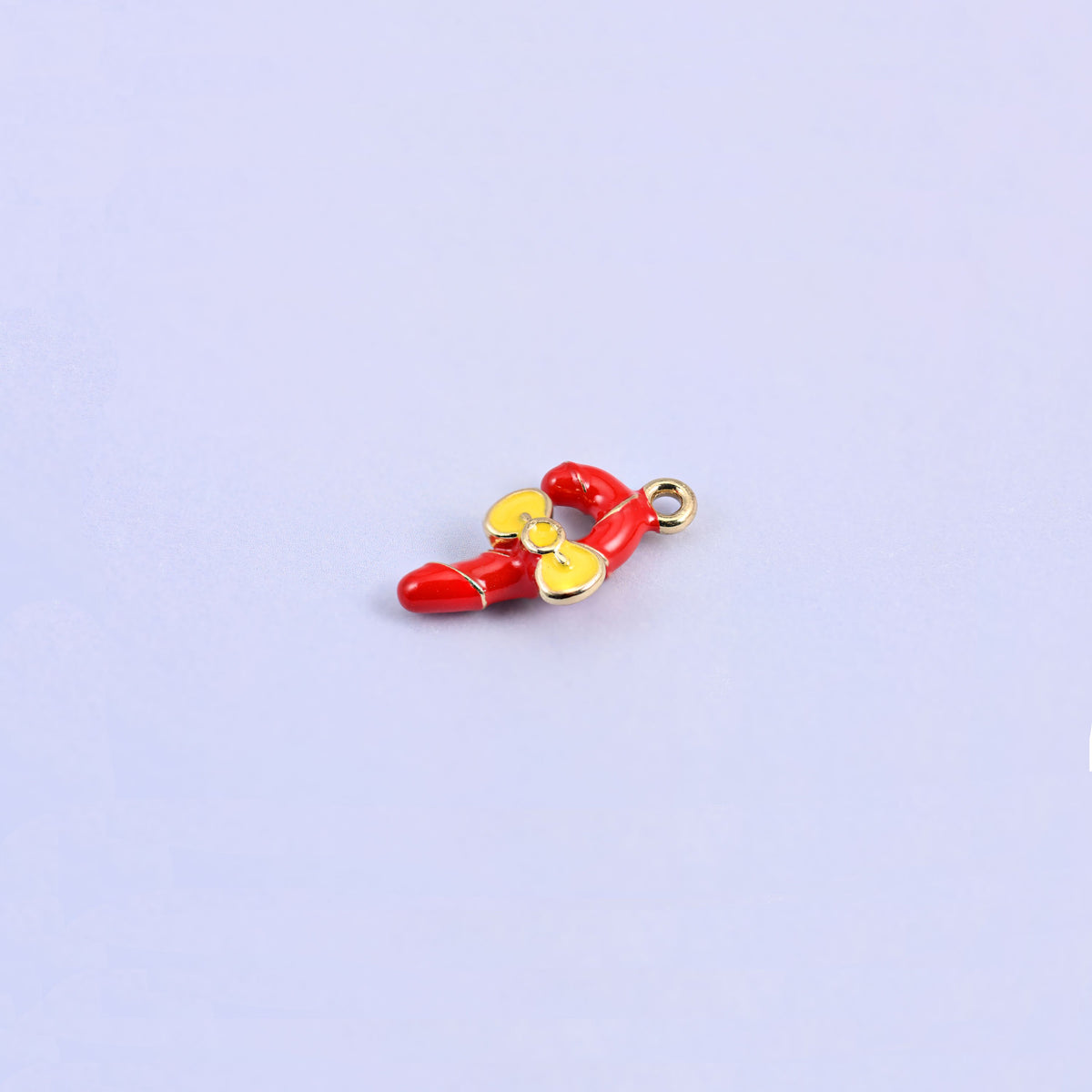 Red candy cane charm lying at an angle, showing the 4.12mm thick three dimensional hook.