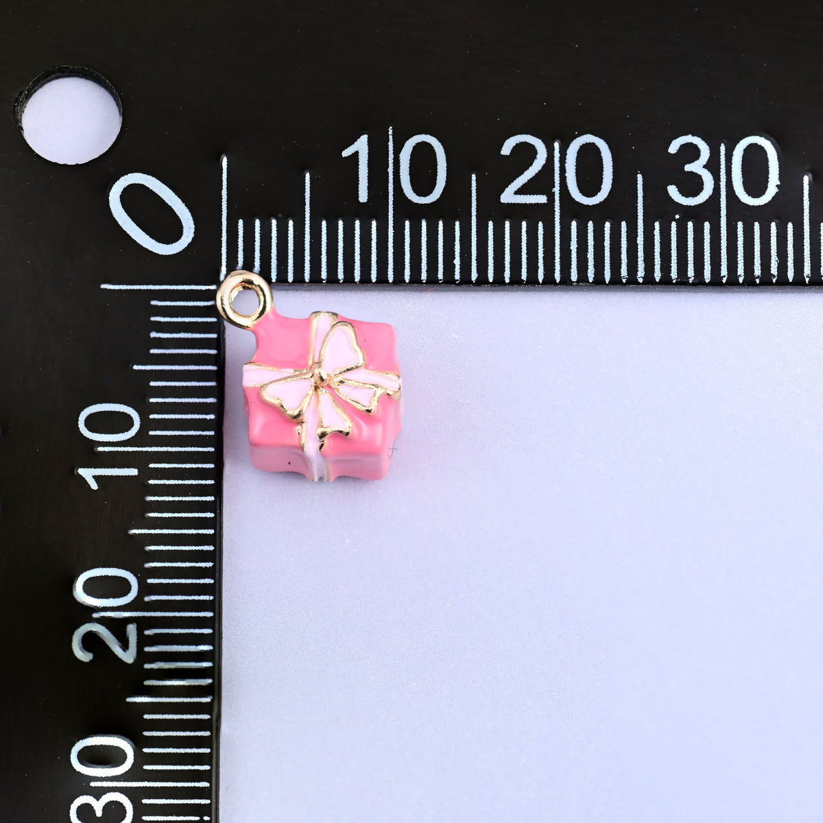 Pink gift box charm measured at 9.44 x 9.38mm including the small ring.