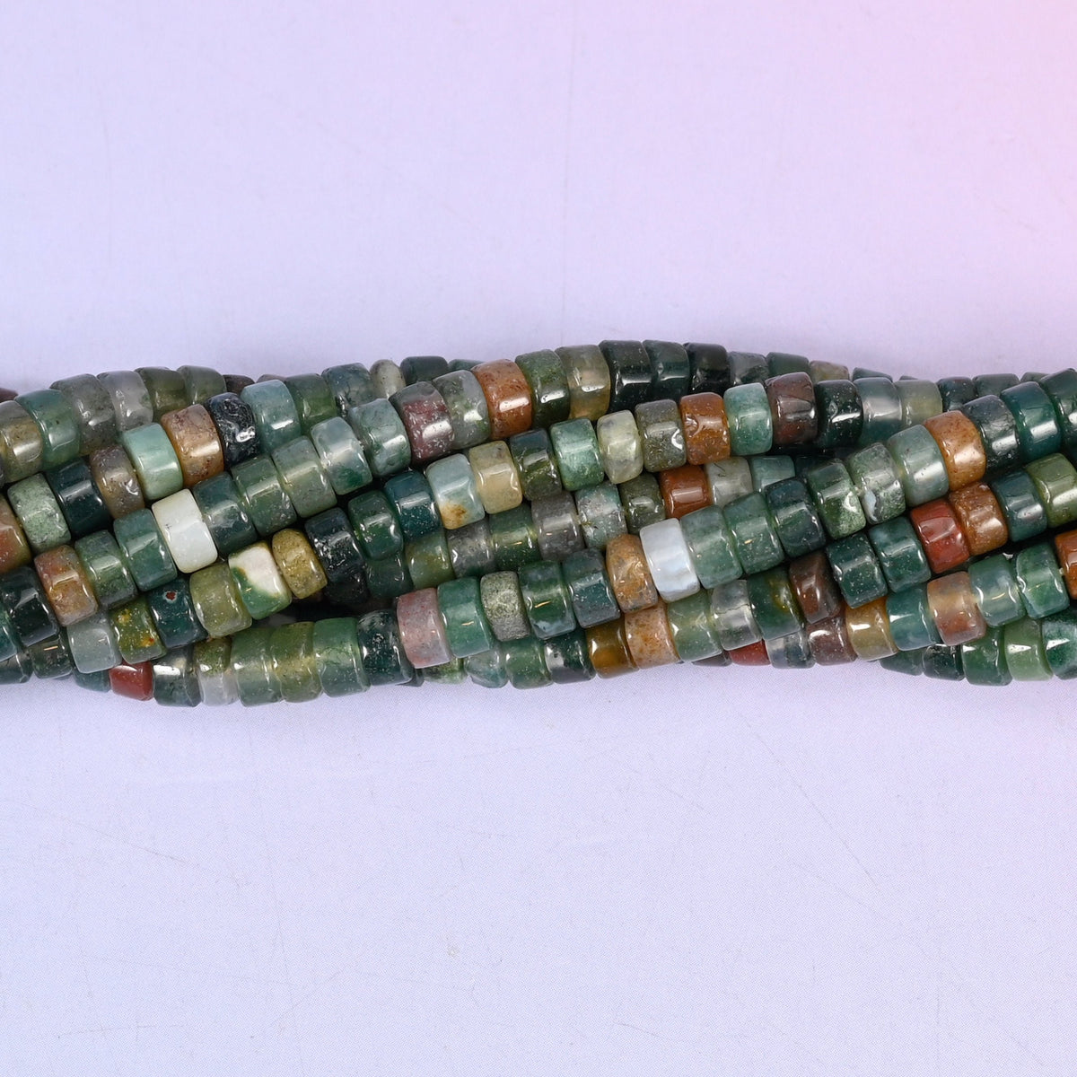 Natural Indian Agate smooth heishi disc beads in a rich mix of forest green, moss, rust, and cream tones, finished with a polished, sophisticated look.