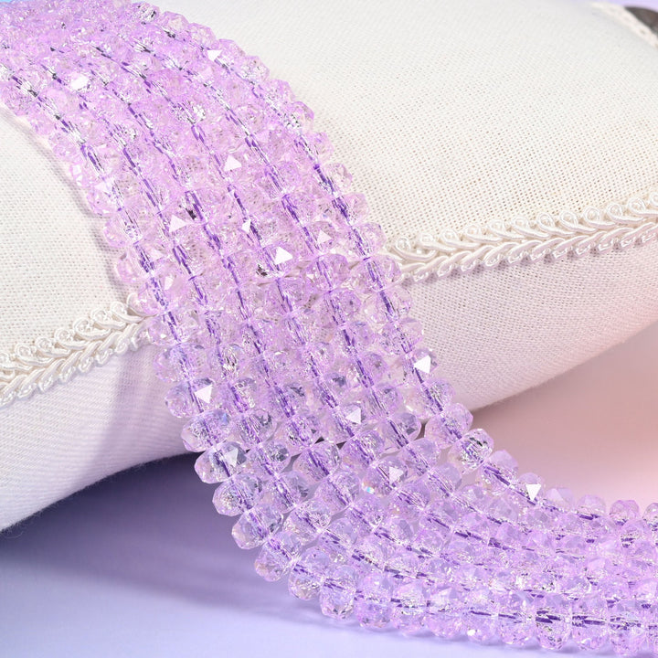 Transparent purple faceted rondelle glass beads in soft lilac, clear right through
