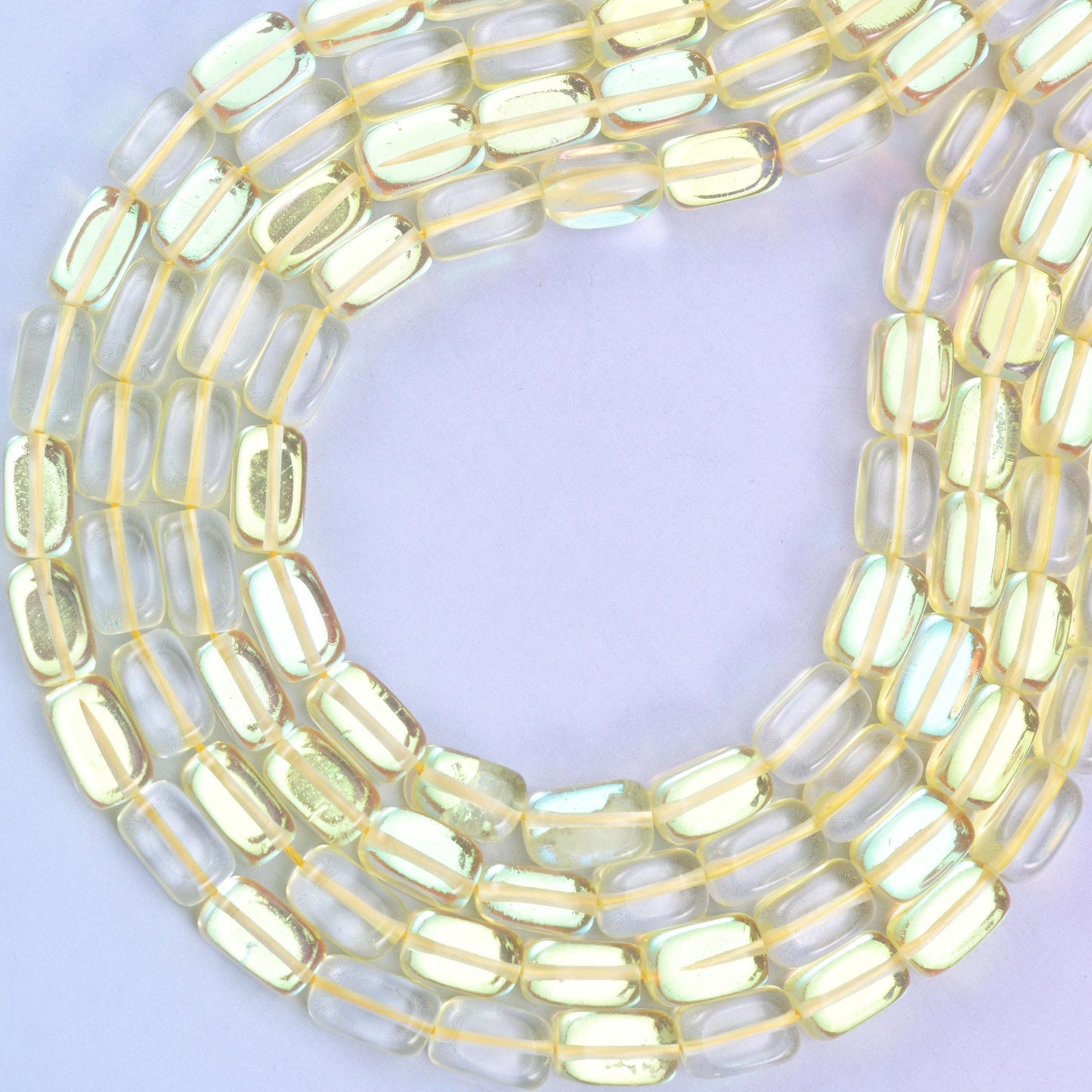 Yellow Mystic Aura glass beads, approximately 34 beads per strand