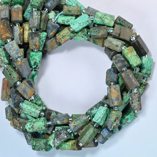Azurite chrysocolla faceted tube beads coiled into overlapping loops, whole strands of green, brown and blue stone