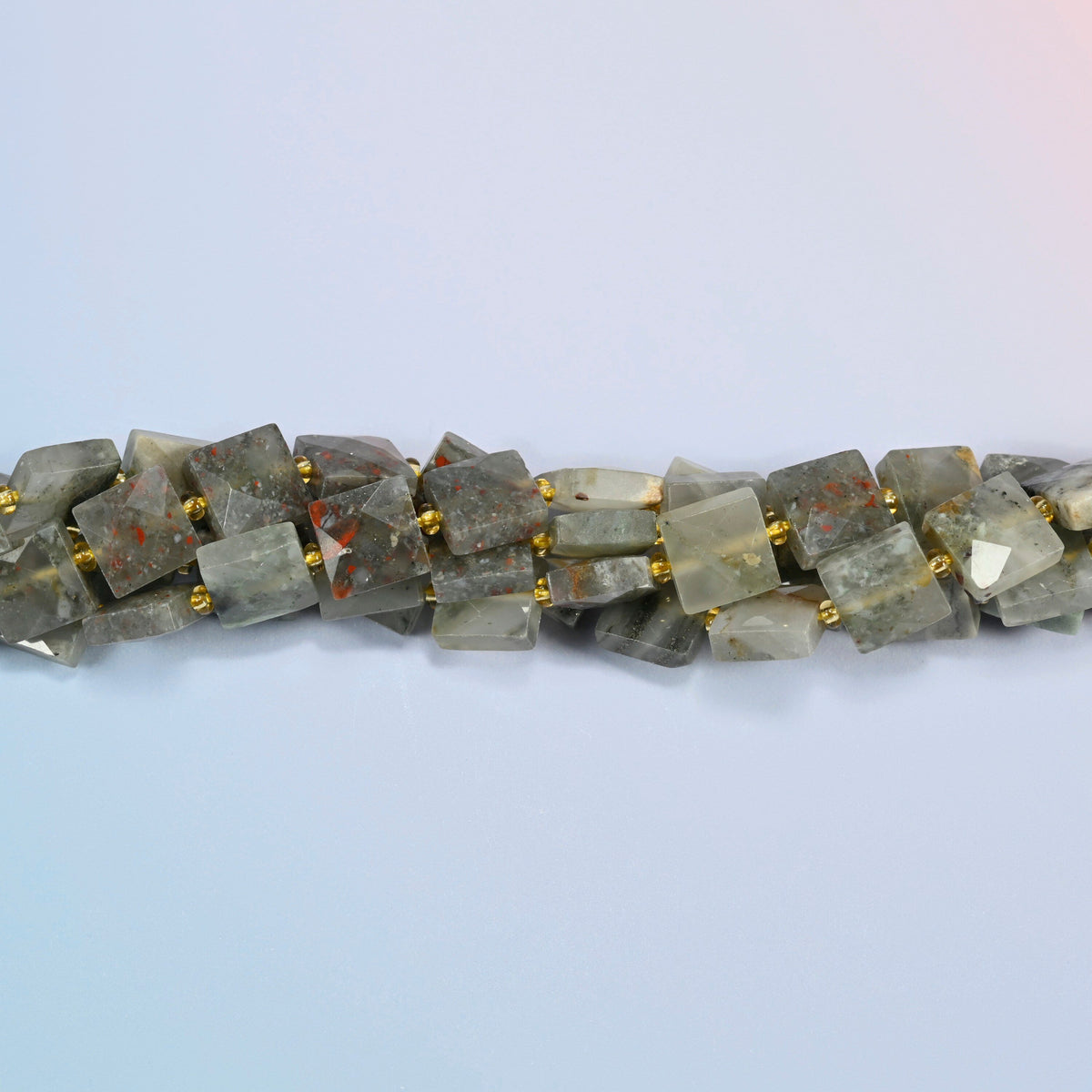 Strands of natural African bloodstone faceted flat square beads twisted together in a horizontal row