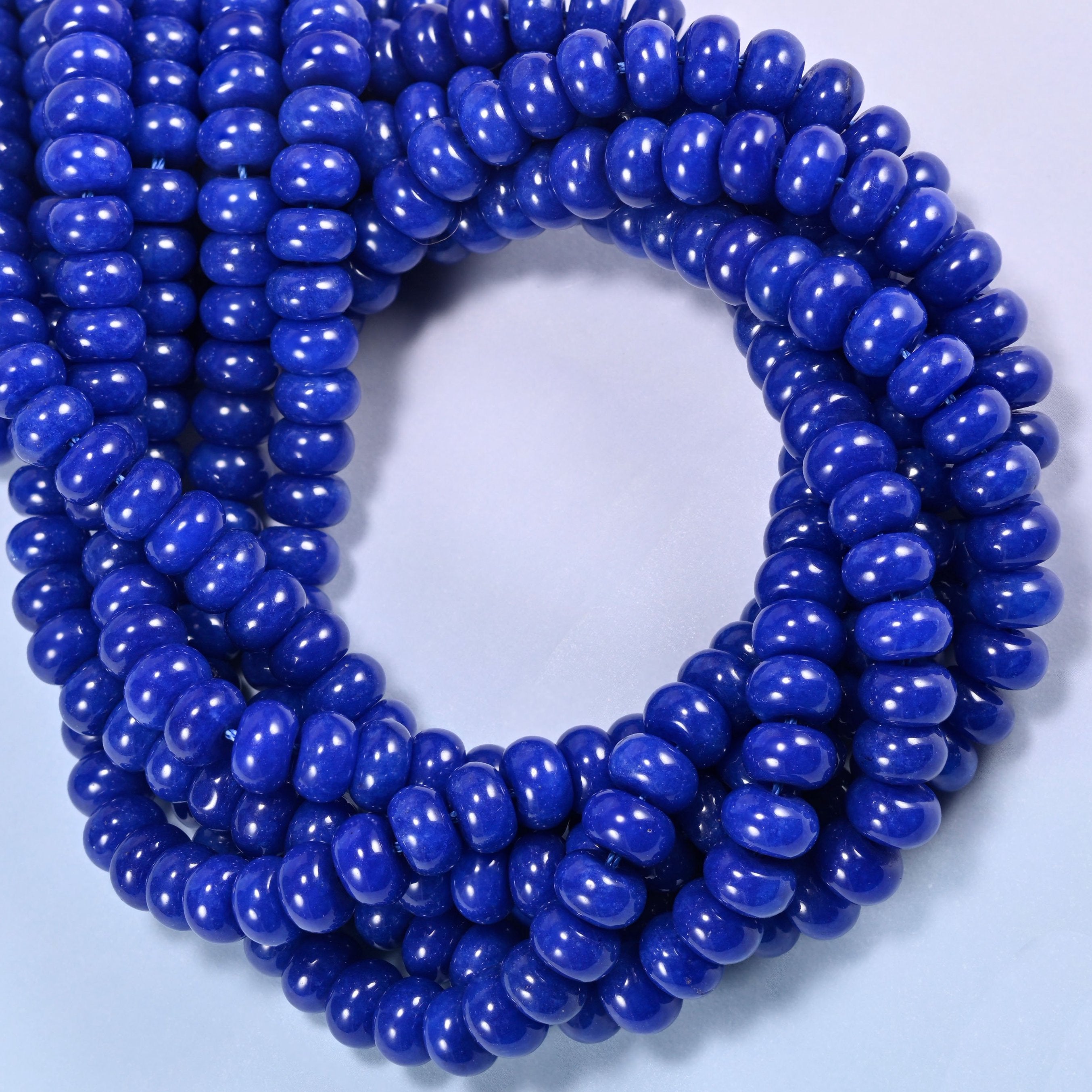 Dark Blue dyed jade gemstone rondelle beads coiled into a ring, even deep blue across the whole strand