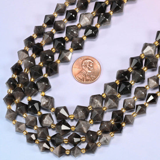 Silver obsidian bicone beads in a wide curve, available in 8mm and 10mm, with a gold-tone spacer between each bead.