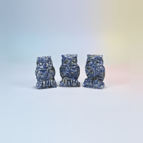 Owl crystal carving in blue spot jasper, white natural stone with blue spots