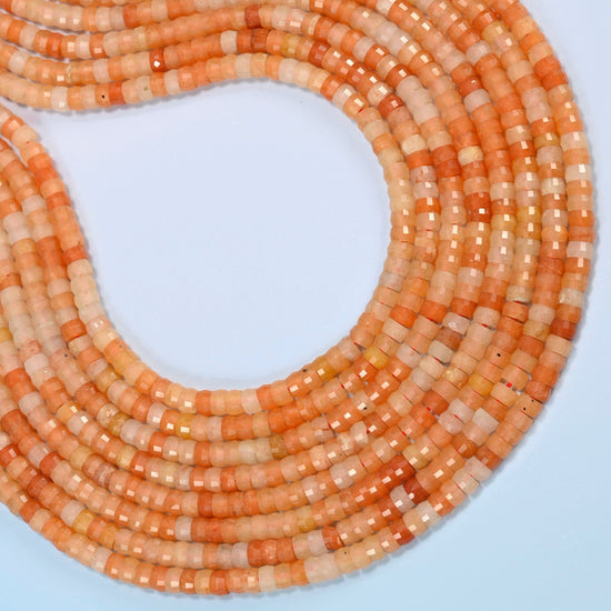 Red aventurine faceted heishi disc beads curved into an open loop, orange-red and peach orange beads