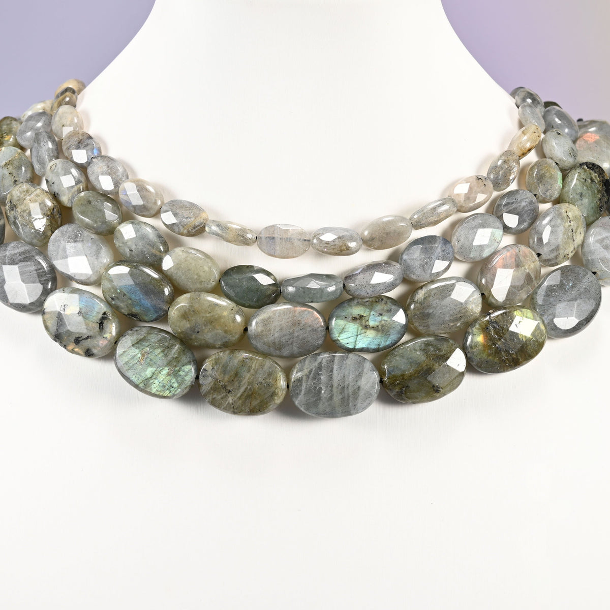 Gray Labradorite faceted oval beads layered as a collar, several strands showing the 8x12mm through 15x20mm sizes