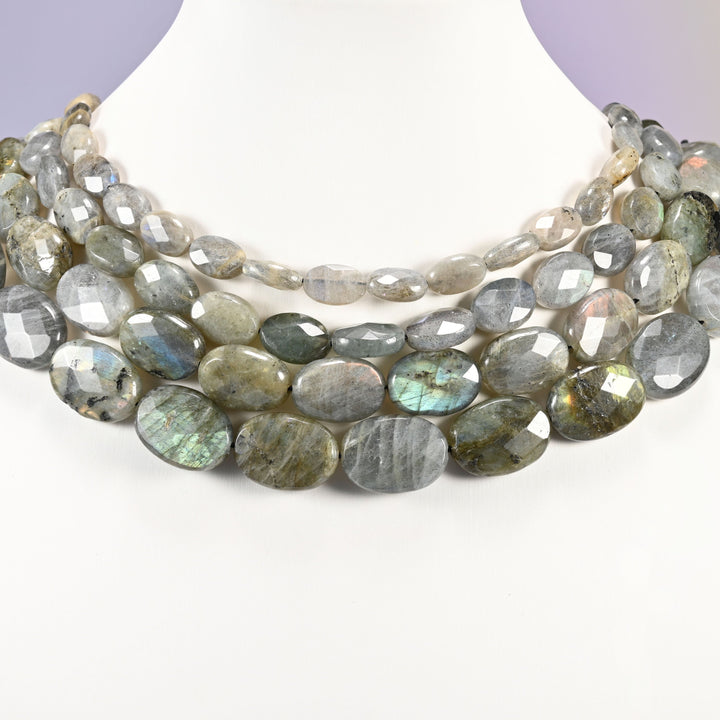 Gray Labradorite faceted oval beads layered as a collar, several strands showing the 8x12mm through 15x20mm sizes