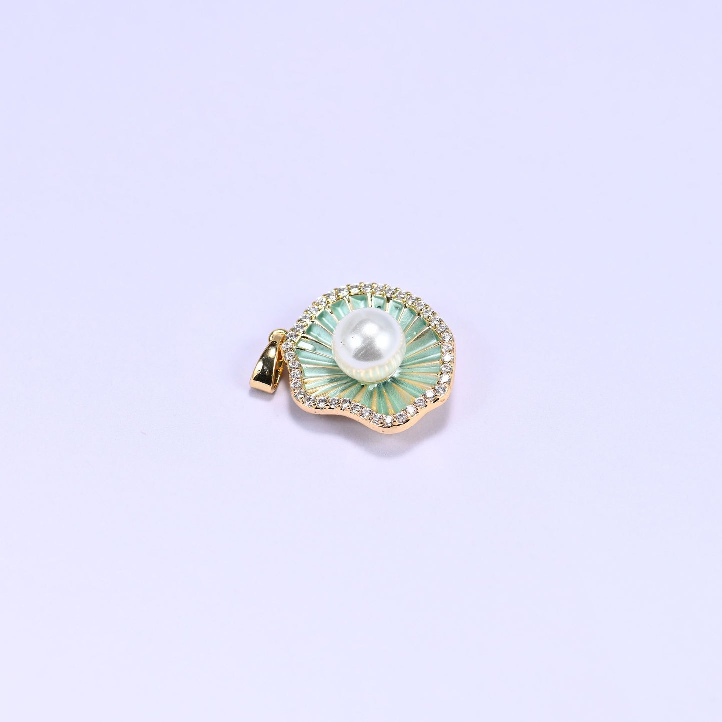 Shell charm with a faux pearl center and a clear zircon border