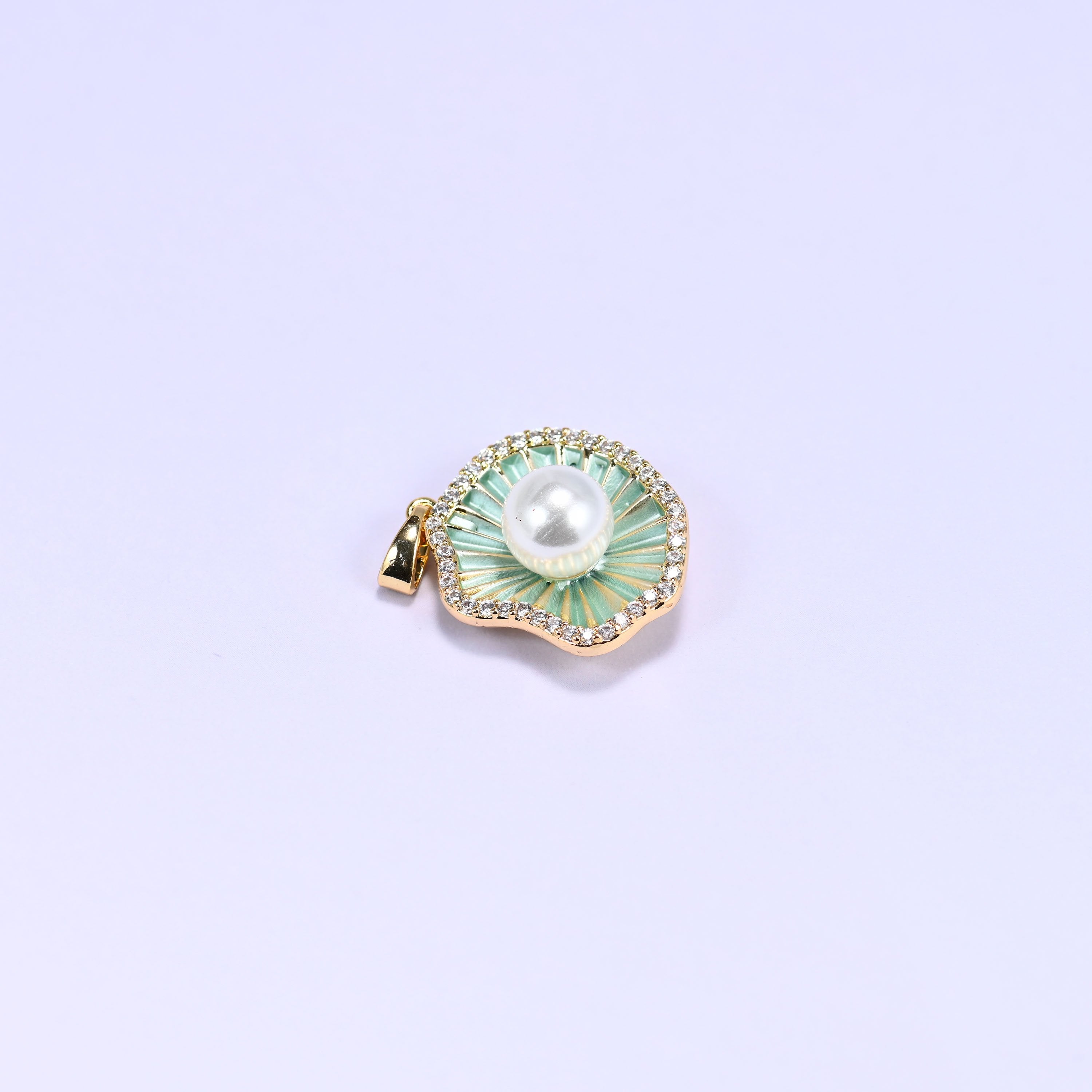 Shell charm with a faux pearl center and a clear zircon border