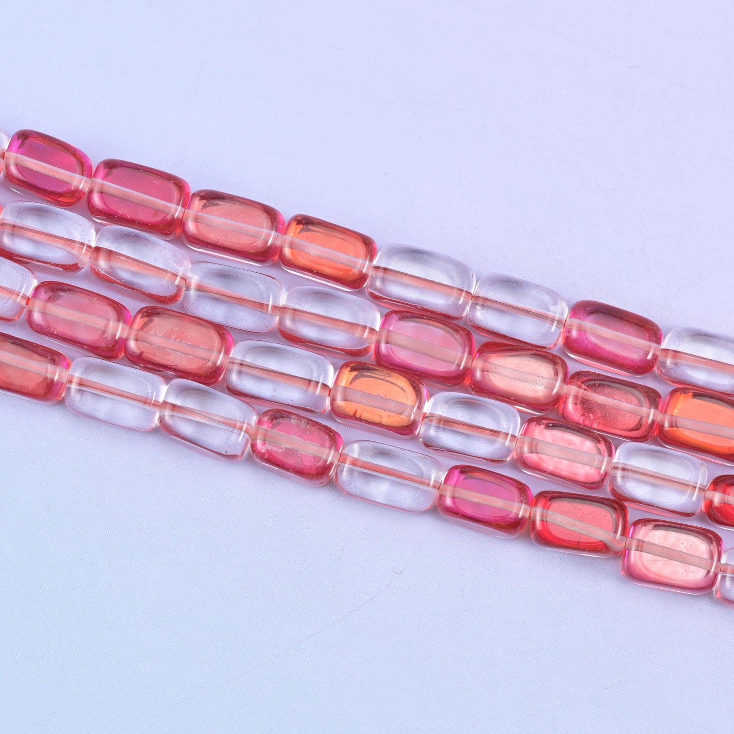 Red Mystic Aura glass beads in a vivid rosy-red shine with a subtle iridescent glow