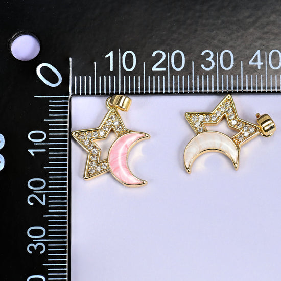 Pink and white Star Shell Moon Zirconia Charms on a black millimeter ruler, both colorways shown together against the mm markings.