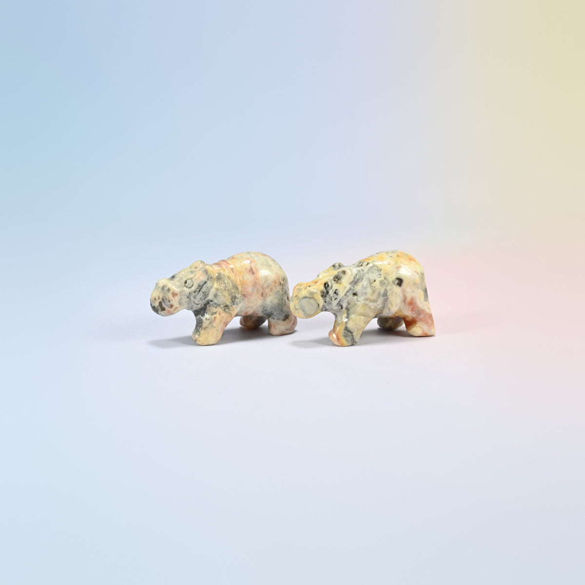 Two natural crazy agate hippo crystal carvings, 2 inch, cream and pink