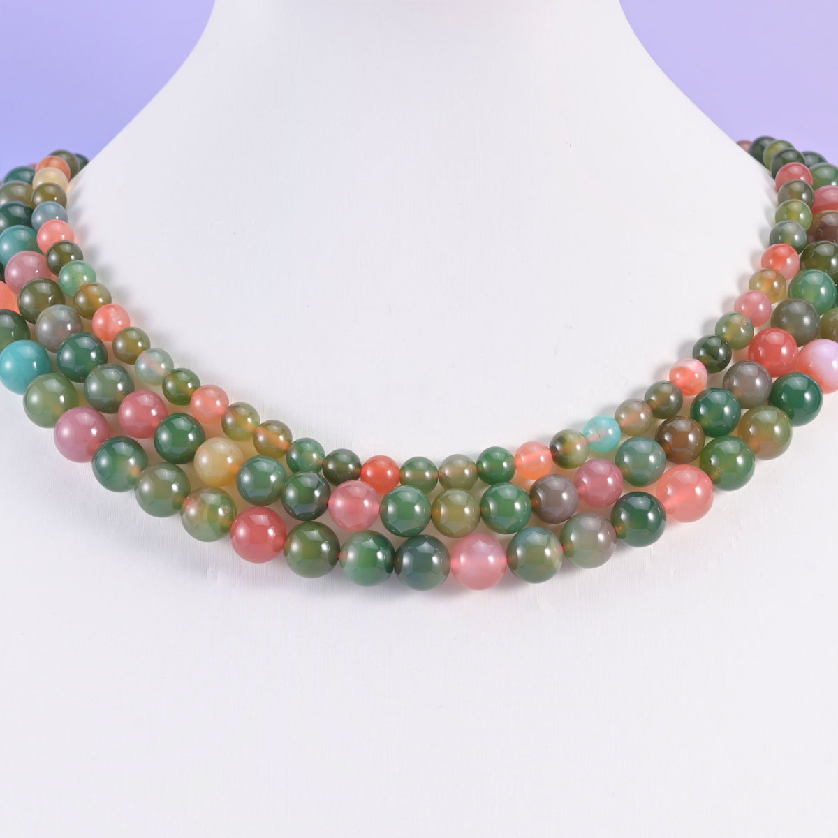 Green Yanyuan Agate round beads looped around a white neck display form, strands in 6mm, 8mm and 9mm together