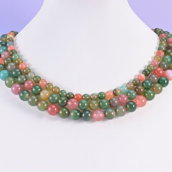 Green Yanyuan Agate round beads looped around a white neck display form, strands in 6mm, 8mm and 9mm together