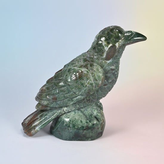 5 inch natural Indian agate crow carving on a rock base, side view facing right, green with red patches