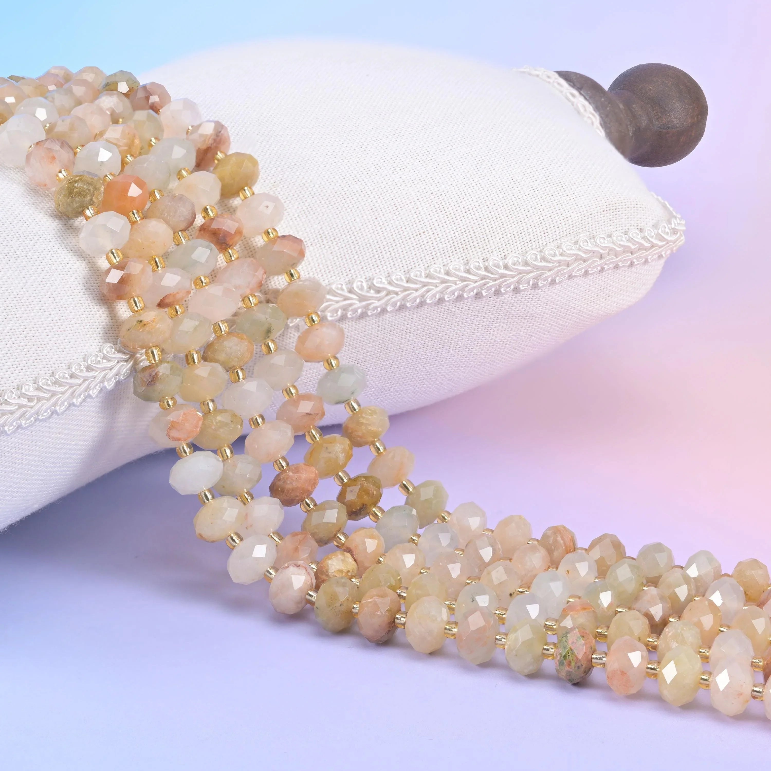 Red Grass Silk faceted rondelle beads in warm champagne, soft peach, and milky cream