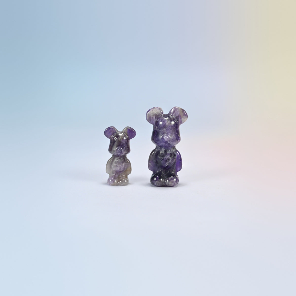 A 1.5 inch and a 2 inch amethyst power bear crystal carving, purple and white natural stone